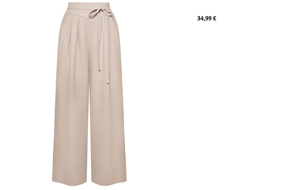 Pantalon fluide beige clair à taille haute nouée.